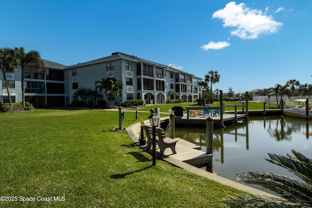 dock area featuring a water view and a yard