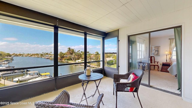 sunroom / solarium with a water view