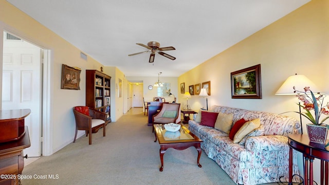 living area featuring ceiling fan, carpet flooring, and visible vents