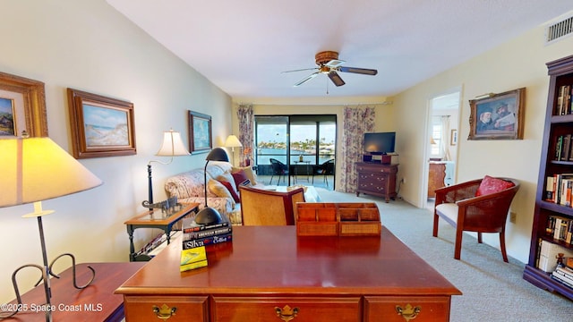 carpeted office space featuring visible vents and a ceiling fan