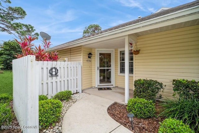 doorway to property featuring fence