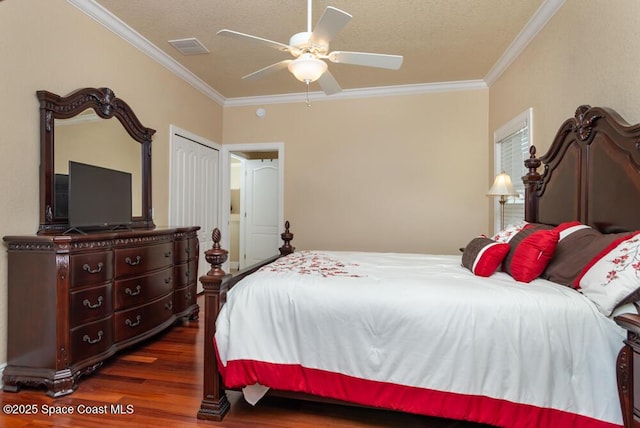 bedroom with a ceiling fan, crown molding, visible vents, and dark wood-type flooring