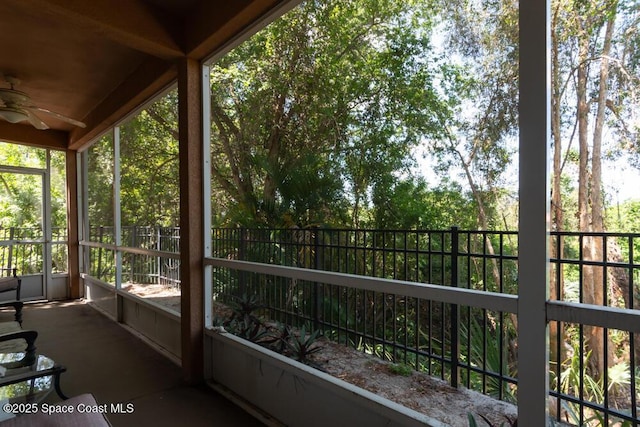 unfurnished sunroom featuring a ceiling fan