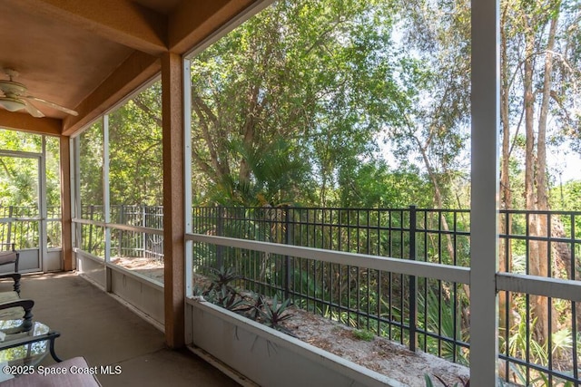 unfurnished sunroom with ceiling fan