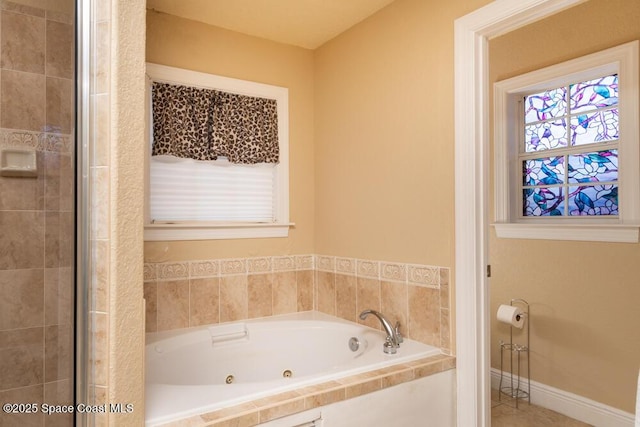 bathroom with baseboards and a whirlpool tub