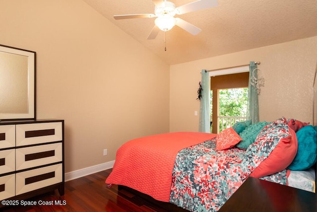 bedroom featuring dark wood-style flooring, vaulted ceiling, a textured ceiling, ceiling fan, and baseboards