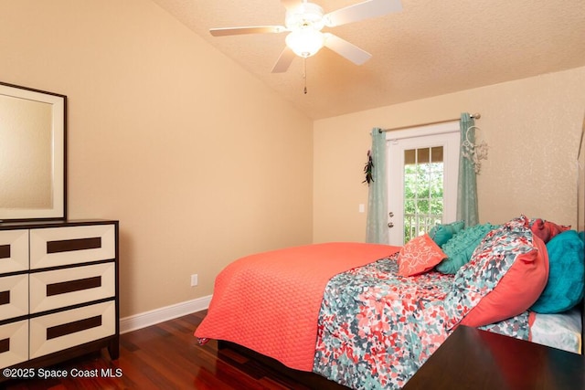 bedroom featuring a ceiling fan, dark wood-style flooring, vaulted ceiling, and baseboards