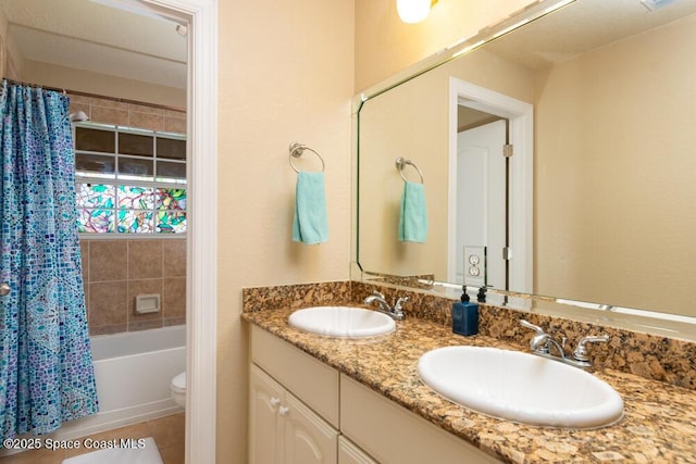 bathroom with shower / bath combination with curtain, a sink, toilet, and double vanity