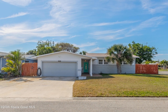 ranch-style home with an attached garage, driveway, fence, and a front yard