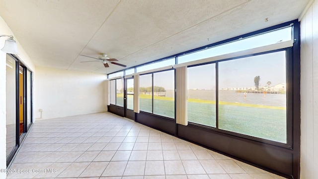 unfurnished sunroom featuring ceiling fan