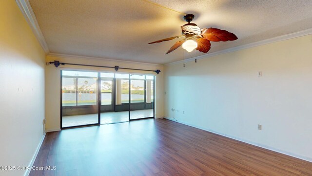 unfurnished room featuring a textured ceiling, ceiling fan, wood finished floors, baseboards, and ornamental molding