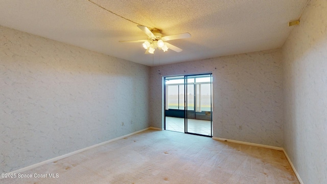 unfurnished room with ceiling fan, a textured ceiling, carpet flooring, and baseboards