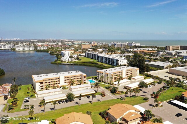 birds eye view of property with a water view and a city view