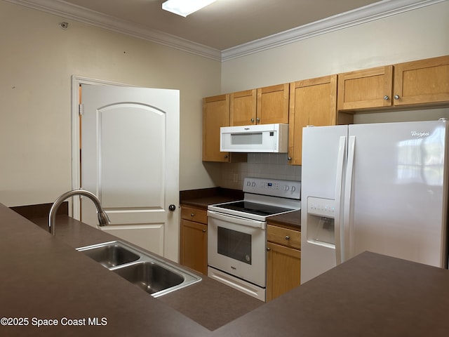 kitchen featuring crown molding, dark countertops, decorative backsplash, a sink, and white appliances