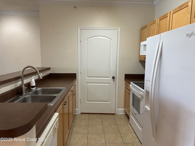 kitchen featuring dark countertops, white appliances, ornamental molding, and a sink