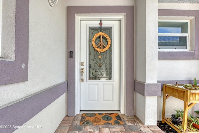 entrance to property with stucco siding