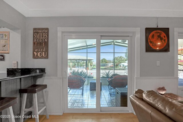 doorway featuring a wainscoted wall