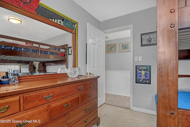 bedroom featuring a wainscoted wall