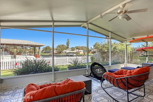 sunroom / solarium with vaulted ceiling with beams and a ceiling fan