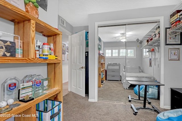 home office featuring visible vents, carpet floors, baseboards, and a ceiling fan