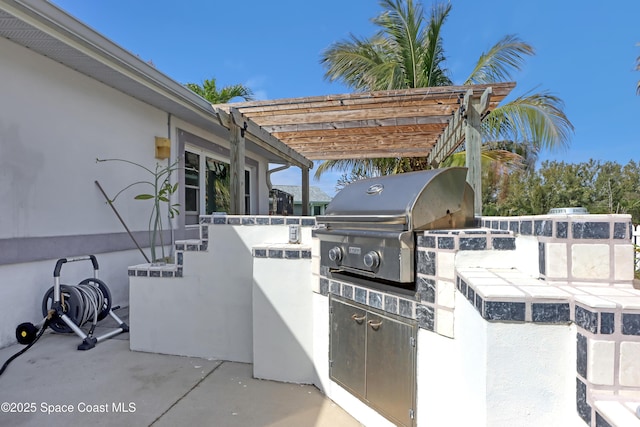 view of patio / terrace featuring area for grilling, exterior kitchen, and a pergola