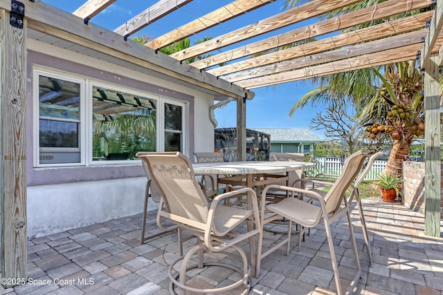 view of patio / terrace featuring outdoor dining area, fence, and a pergola