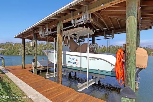 dock area with boat lift and a water view