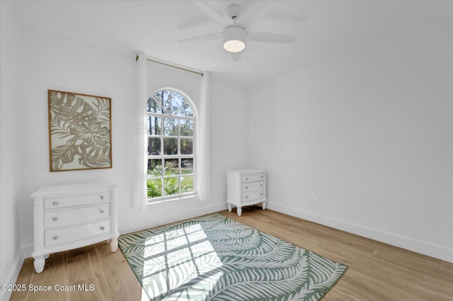 interior space with light wood-style floors, ceiling fan, and baseboards