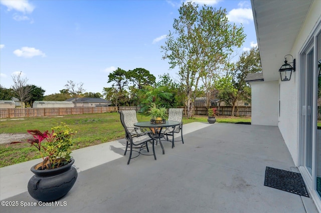 view of patio featuring a fenced backyard and outdoor dining area