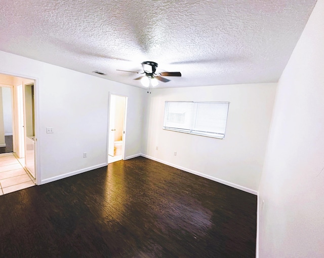 631 Ridge Club Dr Unit 16, Melbourne, FL 32934 - spare room featuring baseboards, visible vents, ceiling fan, wood finished floors, and a textured ceiling