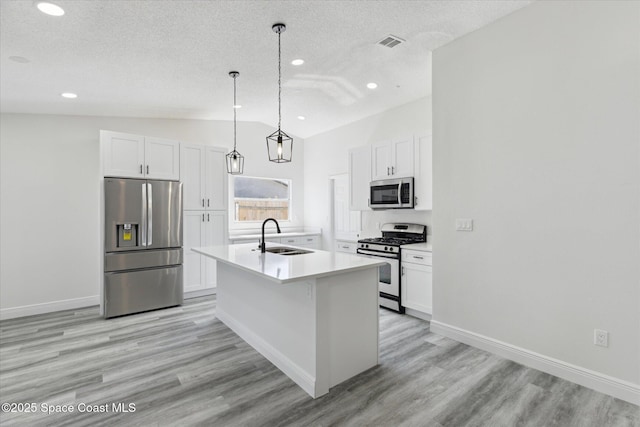 kitchen featuring stainless steel appliances, visible vents, a sink, and white cabinetry