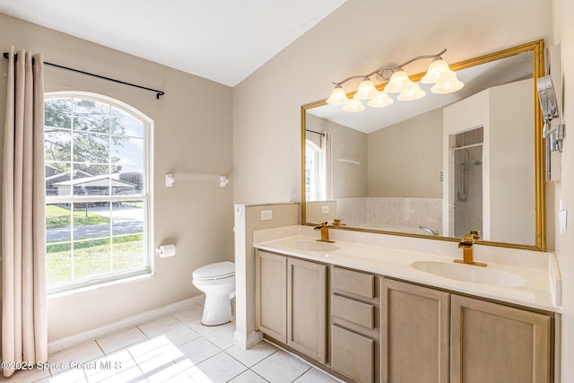 full bath featuring vaulted ceiling, tile patterned flooring, a sink, and a shower stall