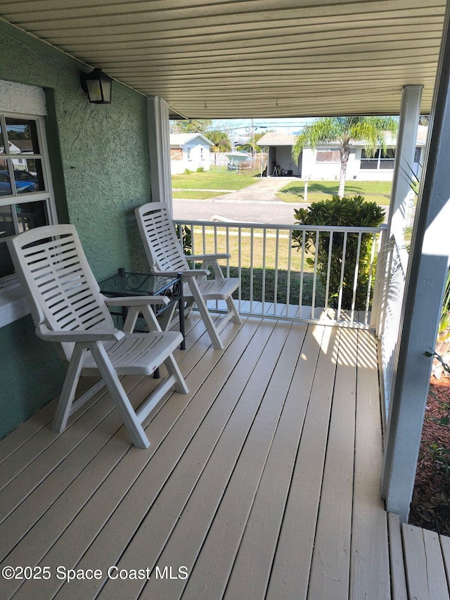 wooden terrace with a porch