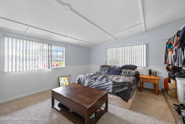 carpeted bedroom featuring lofted ceiling