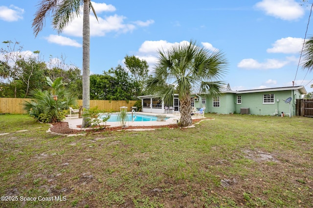 view of yard featuring a fenced in pool, a patio, a sunroom, cooling unit, and a fenced backyard