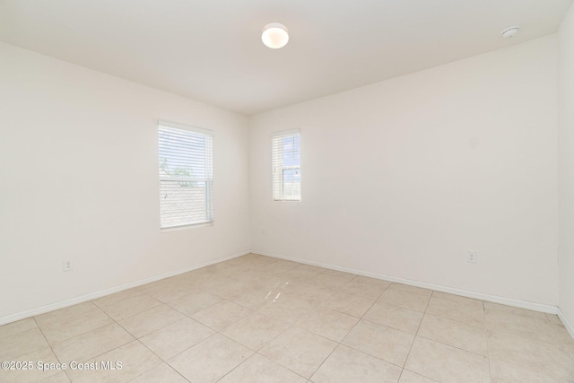 spare room featuring baseboards