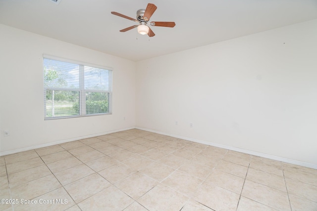 unfurnished room featuring ceiling fan and baseboards