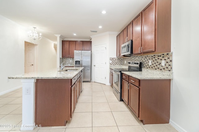 kitchen featuring stainless steel appliances, ornamental molding, an island with sink, and light tile patterned floors