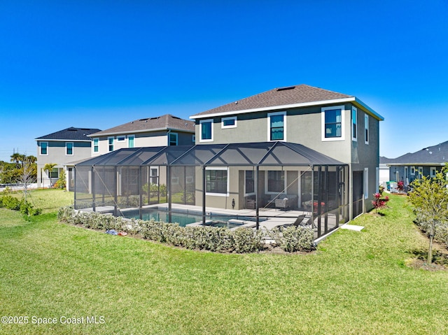 rear view of property featuring a patio, stucco siding, a lawn, a lanai, and an outdoor pool