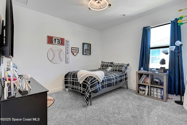 carpeted bedroom with a textured ceiling and baseboards