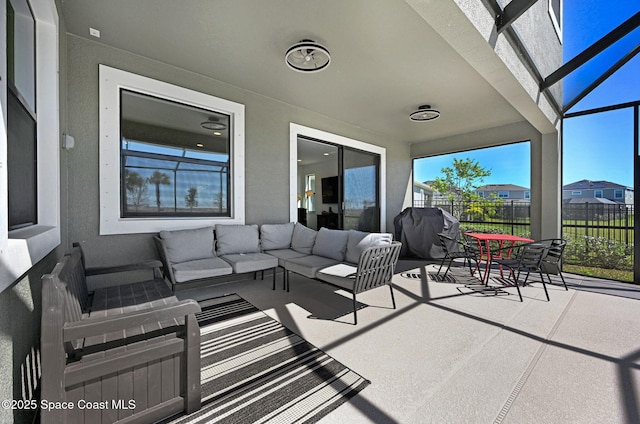 view of patio / terrace featuring an outdoor hangout area, glass enclosure, fence, and a grill