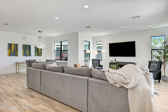 living area featuring light wood-style flooring, visible vents, and recessed lighting