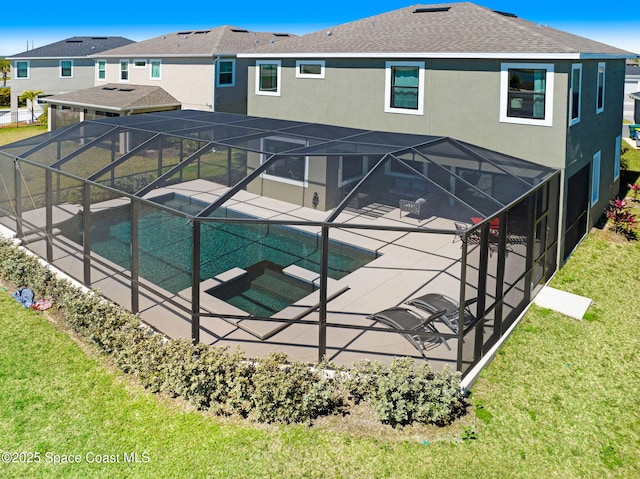 back of property with glass enclosure, a patio area, and stucco siding