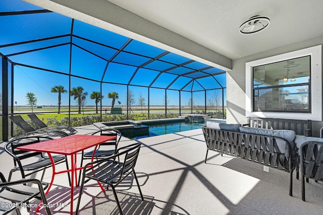 view of pool with glass enclosure, a patio area, and a pool with connected hot tub