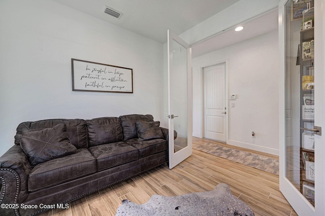 living room with baseboards, visible vents, wood finished floors, french doors, and recessed lighting