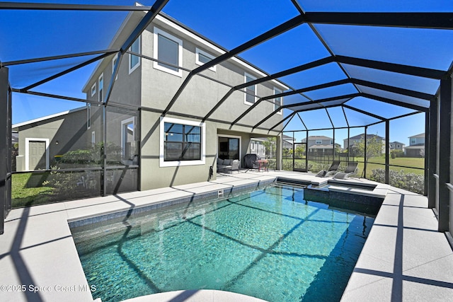 view of pool featuring glass enclosure, a patio area, and a pool with connected hot tub