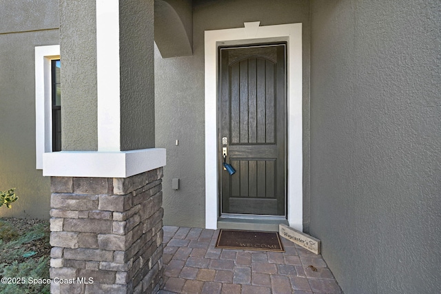 doorway to property with stucco siding