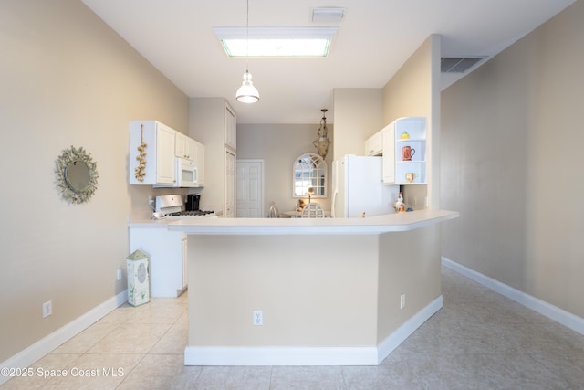 kitchen with white appliances, light countertops, visible vents, and open shelves