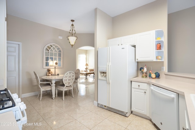 kitchen with arched walkways, white appliances, white cabinets, light countertops, and decorative light fixtures