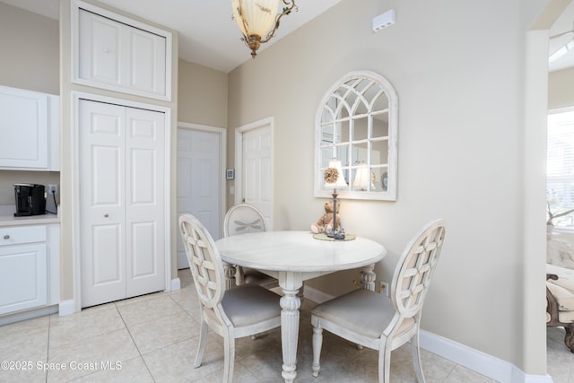 dining area featuring baseboards and light tile patterned floors